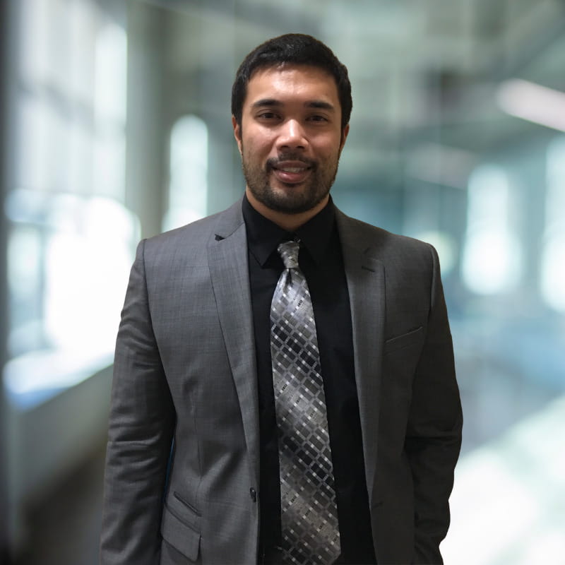 Professional portrait of The Newprint Group owner, Kevin Canaber, in a grey suit.
